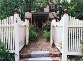 Umpleby House Bed & Breakfast Inn, front entrance, brick walkway, white picket fence, plants and trees.